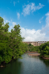 Fototapeta premium Water flowing through a Dam with Trees on the bank