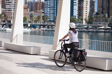 young girl riding a bicycle through the port © J.M. REQUENA