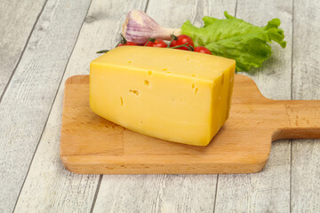 Hard yellow tasty cheese brick