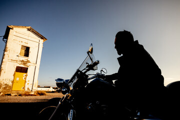 man with black road motorcycle