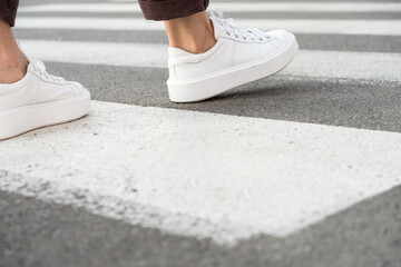 female feet crossing the crosswalk
