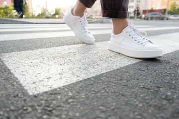 female feet crossing the crosswalk
