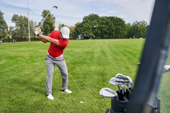 Experienced male golfer training on the course