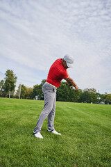 Experienced Caucasian golfer improving his golf technique