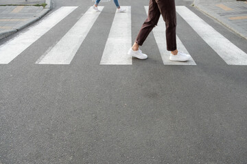 female feet crossing the crosswalk