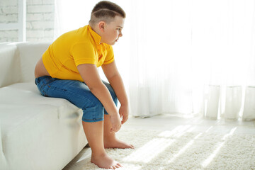 A boy with metabolic disorders. Child with the problem of childhood obesity. Overweight obese fat boy. High quality photo.