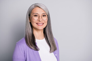 Portrait photo of friendly smiling happy business lady wearing eyeglasses and casual outfit isolated on grey color background