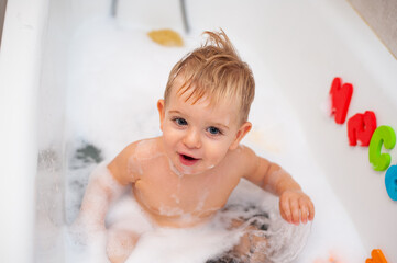 baby in bathtub with foam