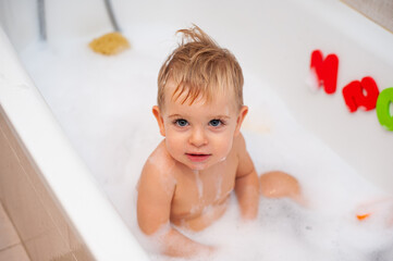 baby in bathtub with foam