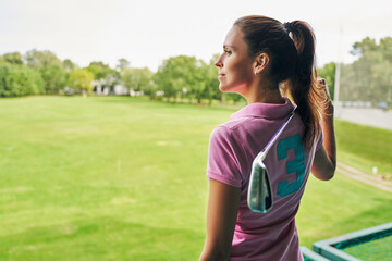 Pensive golf player gazing into the distance