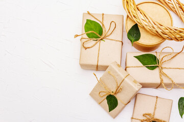 Zero waste gift concept with craft boxes and green leaves
