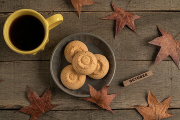 october template with coffee and cookies on wooden table decorated dried autumn leaves