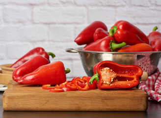 sliced red pepper on a cutting wooden board