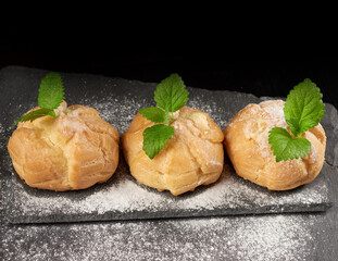 baked custard eclairs and sprinkled with powdered sugar