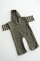 Combed cotton clothes and newborn hats of various colors and types on a white background.