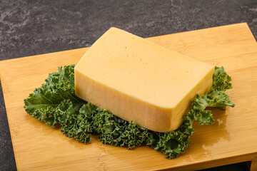 Tasty yelloow Tilsiter cheese brick