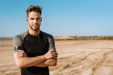 Portrait of a fit sportsman listening to music