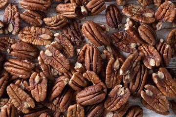 Top view of peeled brown pecan nuts similar to walnuts. Concept of healthy snack. Real size pecan background