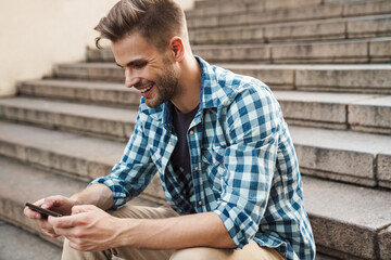 Handsome young man using mobile phone