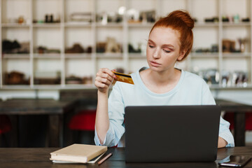 Smiling beautiful woman using laptop