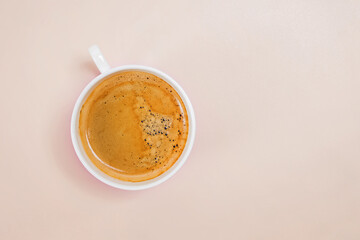 Cup of black coffee on pink background top view