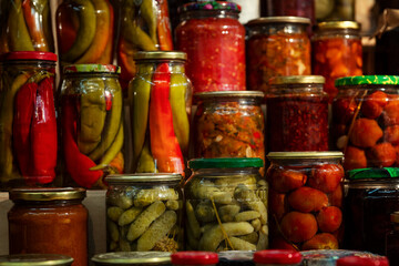 Jars of pickles. Pickled tomatoes, cucumbers and peppers. Russian traditional cuisine.