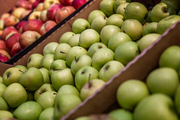 A variety of apples on the counter in the supermarket. Healthy eating and vegetarianism.