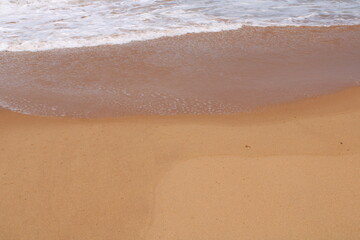 Fototapeta na wymiar waves on the sand in a desert beach