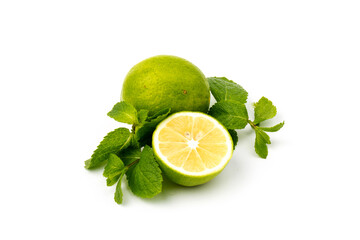 Naklejka na ściany i meble Lime with mint leaves isolated on white background.