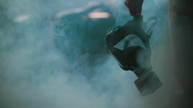 Lonely human in protective gas mask. Protective suit clothes.