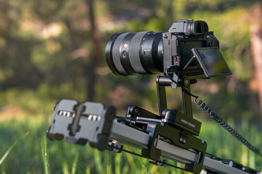 Video camera with professional filming equipment slider