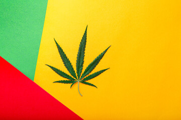 Weed ganja green hemp leaf on rastaman flag, red green yellow background. Cannabis leaf. Weed...