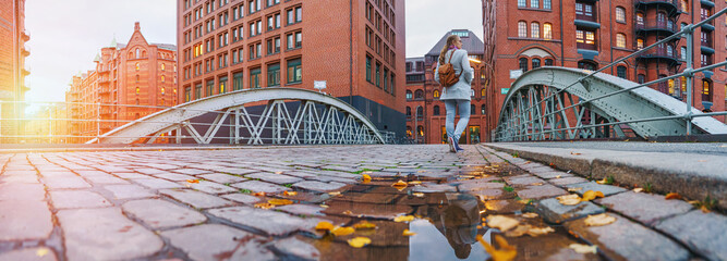 Hamburg - a woman walking in warehouse district