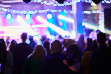Music Concert background blur. Blurred People dancing with original bokeh lights in background -...