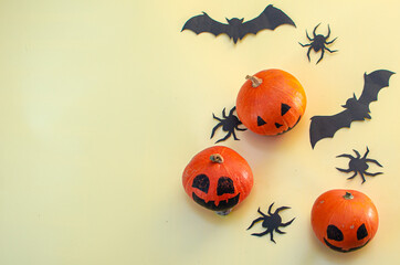 Halloween decoration pumkins on yellow background