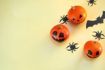 Halloween decoration pumkins on yellow background