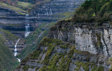 Naklejka premium Autumn landscape at the San Miguel waterfall in the Angulo Valley of the Mena Valley in the Merindades of the province of Burgos. Castilla y Leon, Spain, Europe