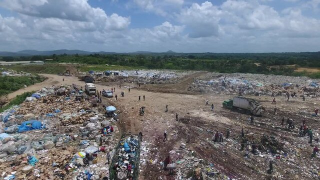 People working with waste in Duquesa landfill, Dominican Republic. Aerial forward