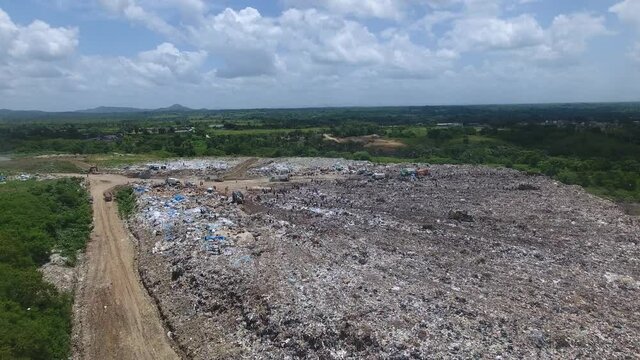 Drone POV over Duquesa landfill and people collecting waste. Santo Domingo