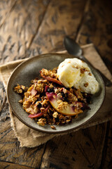 Homemade apple berry crumble with vanilla ice cream