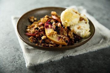 Homemade apple berry crumble with vanilla ice cream