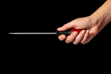 Man hand holding screwdriver on black background, Industrial and business concept, Dark tone.