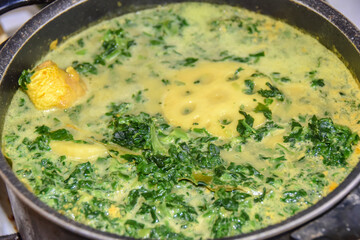 cooking yellow green curry with lotus root and spices