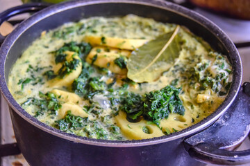 cooking yellow green curry with lotus root and spices