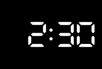 Real white led digital clock on black background