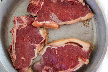 raw argentine beef steak on a pan