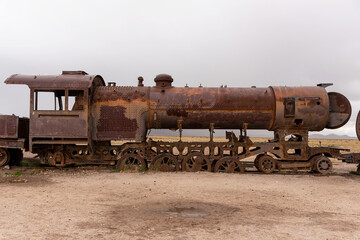 Fototapeta na wymiar Old rusty locomotive abandoned in a train cemetery. Uyuni, Bolivia