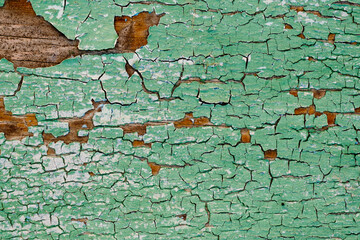 Old green board with cracks. Selective focus.