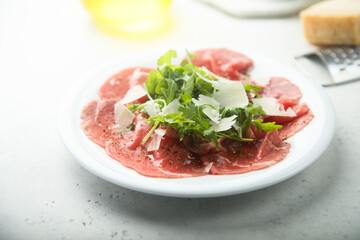 Traditional beef carpaccio with arugula