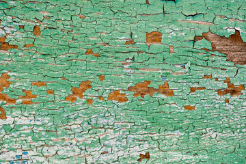 Old green board with cracks. Selective focus.